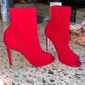 Aldo Red stretchy mid ankle booties, with pink soles.